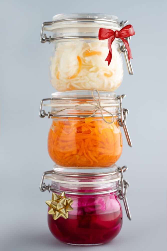 Stack of 3 jars of sauerkraut with ribbons. | MakeSauerkraut.com